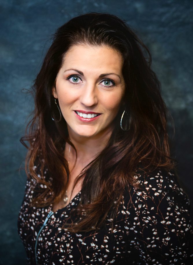 A woman with long hair and blue eyes.